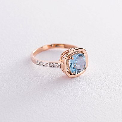 Золота каблучка з блакитним топазом і фіанітами к05439