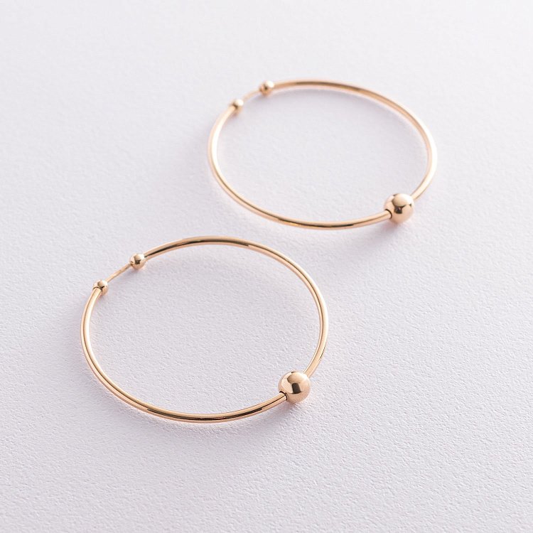 Сережки - кільця "Гармонія" в жовтому золоті с07326 від ювелірного магазину Онікс