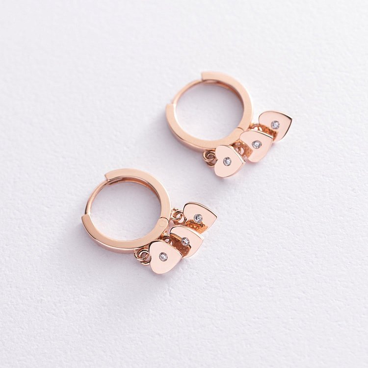 Золоті сережки - кільця "Сердечка" з фіанітами с07476 від ювелірного магазину Онікс