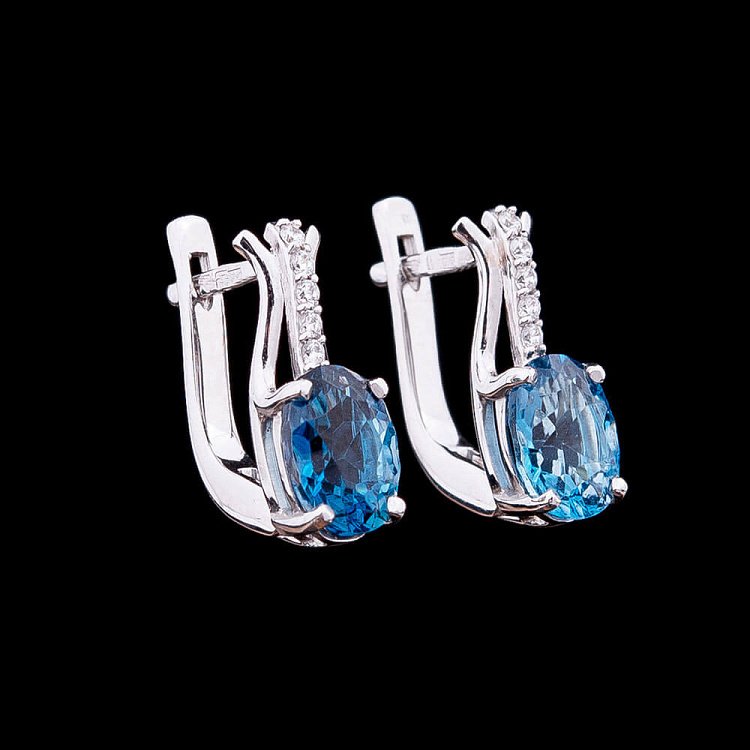 Золоті сережки з блакитним топазом і фіанітами 14050554 від ювелірного магазину Онікс
