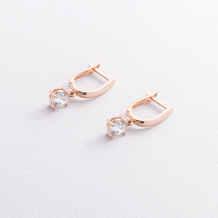 Золоті сережки з фіанітами на англійській застібці с01444 від ювелірного магазину Онікс - 1