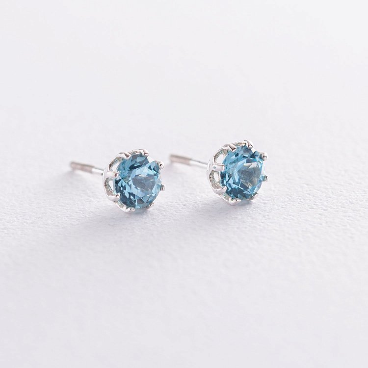 Срібні сережки - пусети (син. топази) 122855 від ювелірного магазину Онікс