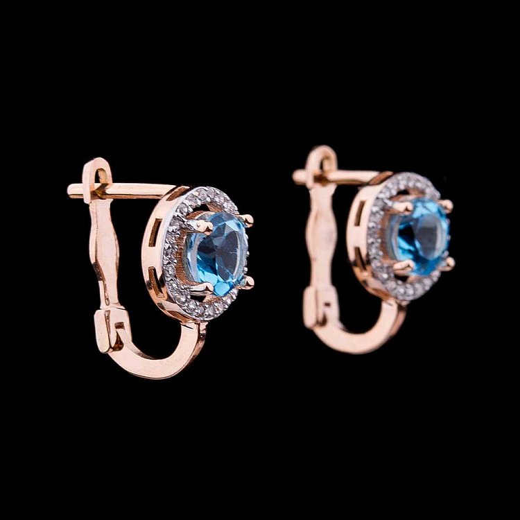 Золоті сережки з блакитним топазом і фіанітами с04165 від ювелірного магазину Онікс