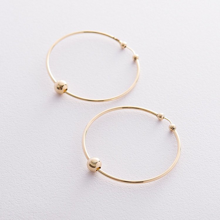 Сережки - кільця Гармонія в жовтому золоті с06691 від ювелірного магазину Онікс