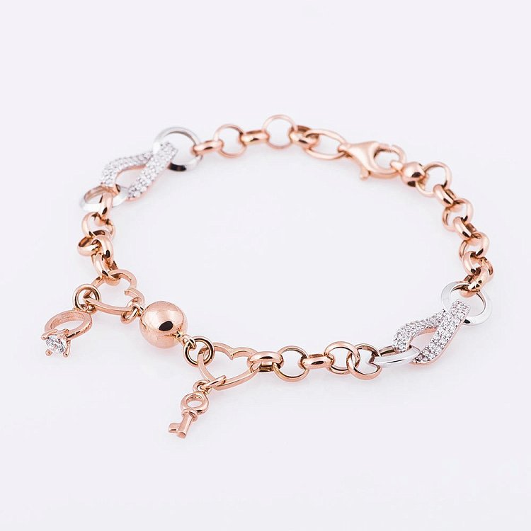 Жіночий золотий браслет з ключиком і колечком (фіаніти) б02799 від ювелірного магазину Онікс