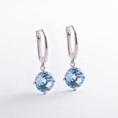 Золотые серьги "Влечение" с голубым топазом с08003