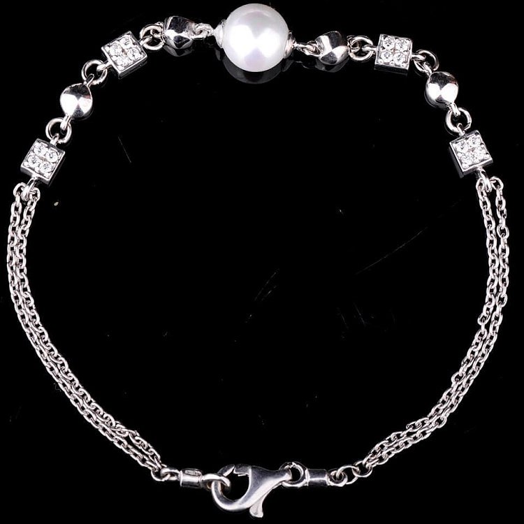 Срібний браслет з культивованими прісноводним перлами 14773 від ювелірного магазину Онікс