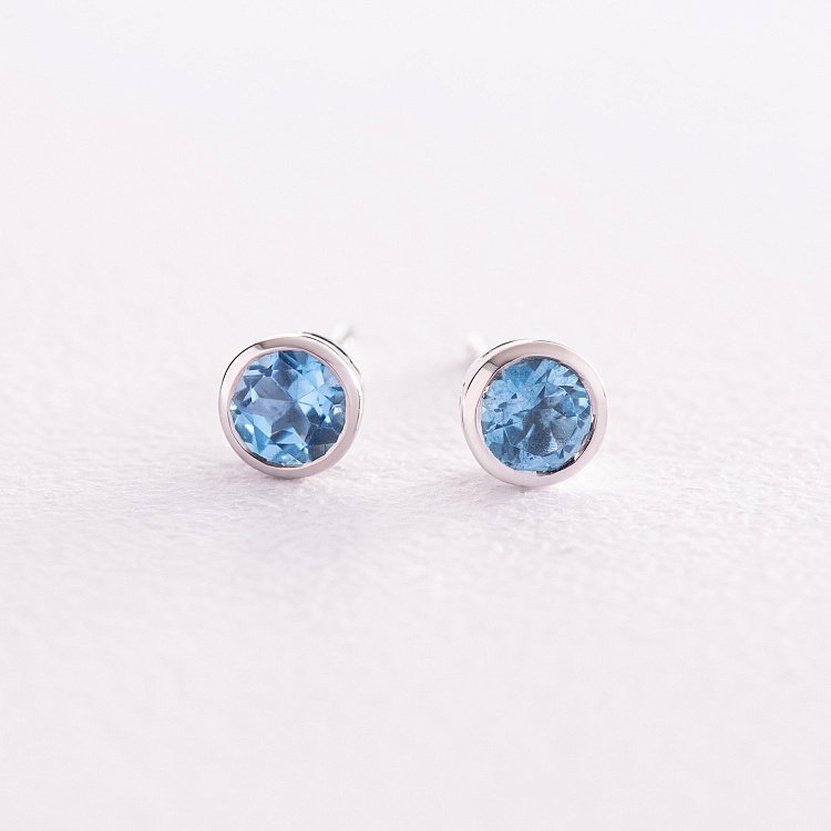 Золоті сережки - пусети з блакитними топазами сб0428gl від ювелірного магазину Онікс