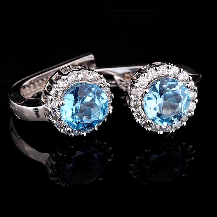 Золоті сережки з блакитним топазом і фіанітами с01684 від ювелірного магазину Онікс