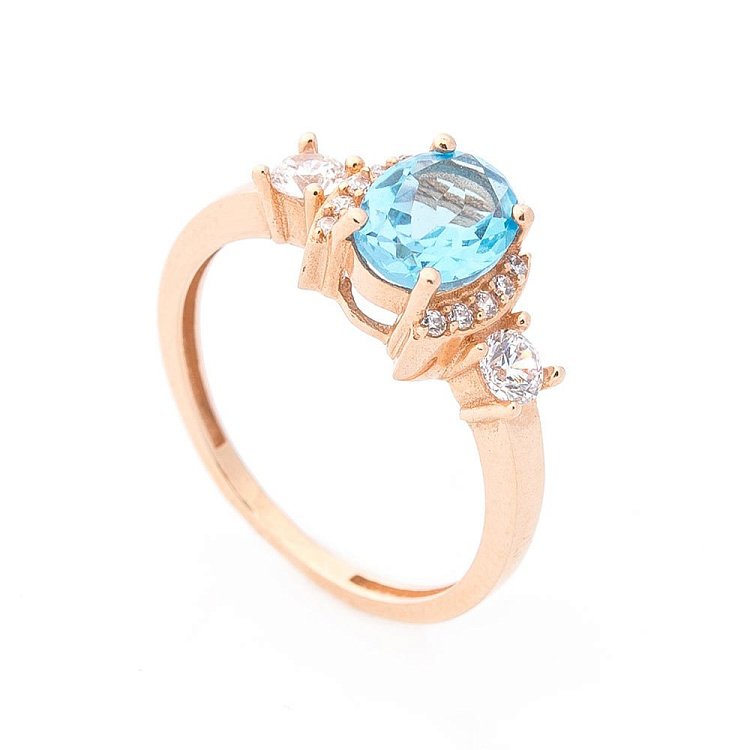 Золота каблучка (блакитний топаз, фіаніти) к04642 Золота каблучка (блакитний топаз, фіаніти) к04642 від ювелірного магазину Онікс